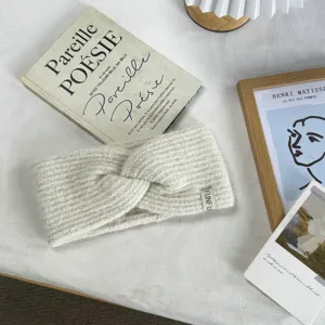 Cozy twist knit headband for women, wide winter warm hair accessory in soft solid color.