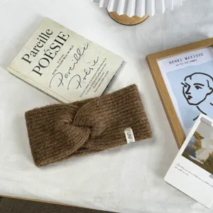 Cozy brown knitted twist headband detail, soft winter warm wide hair accessory for women.