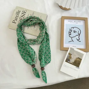 Green snowflake grid knitted long scarf with retro wood beads, elegant accessory for autumn.