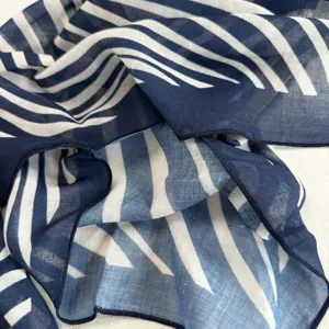 Lightweight blue white striped scarf detail showing soft fabric texture and rolled edges.