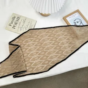 Detailed close-up of a Korean vintage hollow knit triangular scarf with black wavy edges.