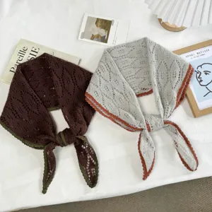 Detailed view of Korean retro hollow knit triangle scarves in brown and grey with contrast edges.