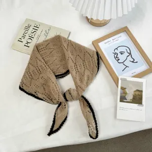 Detailed view of the Korean vintage hollow knitted triangle scarf with chic piped black border.