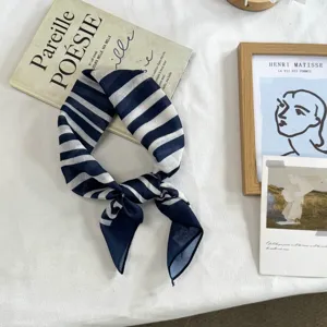 Navy blue and white striped silk square scarf detail, lightweight neckerchief accessory.