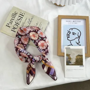 Close-up detail of the vintage floral silk square scarf showing delicate pattern and soft texture.