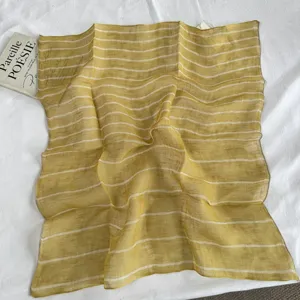 Close-up detail of vintage striped linen square scarf, soft texture, elegant accessory.