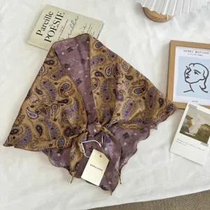 Retro paisley print silk triangular scarf, detailed close-up shot showing elegant fabric texture.