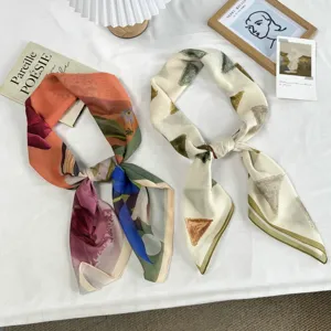 Artistic style square scarf and neck wrap detail featuring abstract floral and geometric brushstrokes.