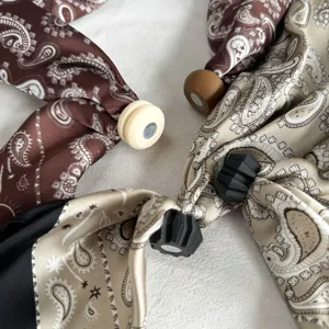 Detailed close-up of vintage paisley print silk scarves with convenient magnetic clasps.