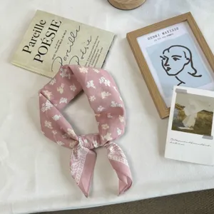 Close-up detail of the pink floral cotton bandana scarf, showing soft fabric and cute design.