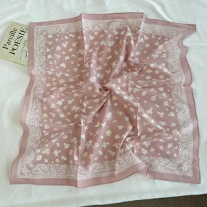 Chic pink floral bandana with classic paisley border, versatile cotton square hair scarf.