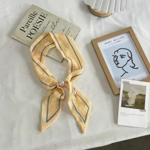 Elegant yellow polka dot skinny scarf with blue stripes and pearl buckle for women's neck wear.