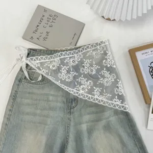 Chic white lace triangle scarf waist accessory paired with denim, perfect for stylish outfits.