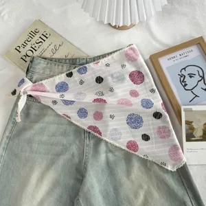 Detailed close-up view of the chic polka dot triangle scarf with delicate lace trim styling.