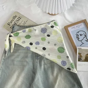 Detailed view of the stylish polka dot triangular scarf, cute summer headscarf and neckerchief.