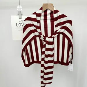 Red and white striped knitted shawl, soft cozy oversized cape for stylish daily commuting wear.