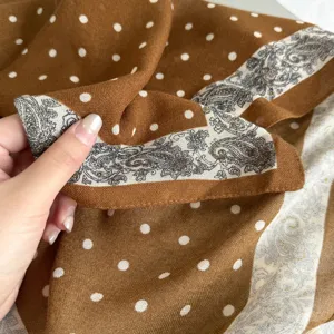 Brown cashmere feel square scarf detail featuring white polka dots and vintage paisley border.