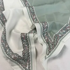 Detail shot of the retro color-blocking triangle scarf, showing delicate geometric border patterns.