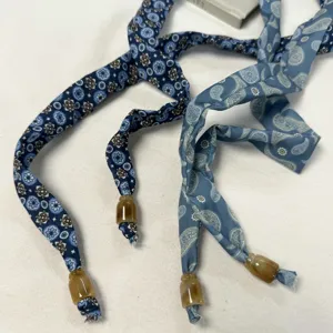 Detailed close-up of retro printed fabric straps with beaded ends, versatile decorative accessory.