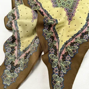 Vintage silk scarf detail showcasing exquisite green, brown and pink paisley patterns.