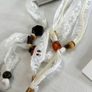 White lace ribbon scarf necklace with resin beads, elegant neck tie accessory for women.