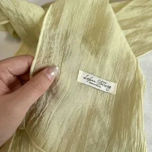 Light yellow crinkled mesh scarf for women, elegant slim long neck ribbon accessory.