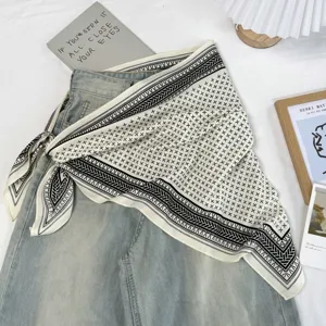 Retro schwarz-weißer geometrischer Dreieckschal als Haaraccessoire und Tuch im Detail.
