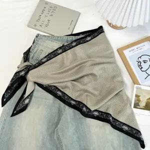 Detailed shot of retro color block triangle scarf styled on denim, chic fashion accessory.