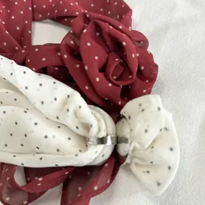 Close-up detail of Korean style polka dot chiffon flower scarf with metal buckle accessory.