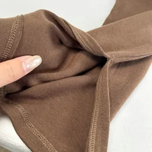Detail view of brown solid color ribbed knit sleeve cover, soft and skin-friendly fabric.