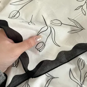 Black white tulip pattern cotton square scarf detail showing fabric texture and scalloped edge.