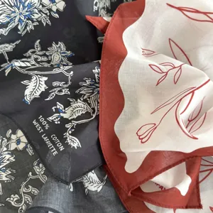 Cotton floral square scarf detail, soft neckerchief fabric texture close up view.