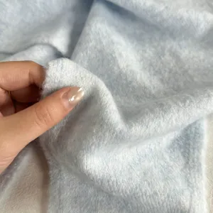 Soft knitted fabric detail of women's stylish solid color scarf, cozy spring summer accessory.