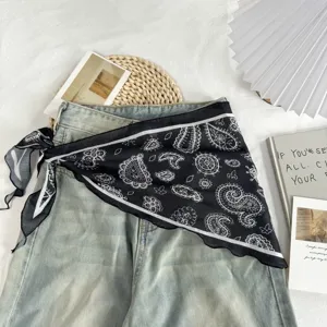 Detailed view of stylish black and white paisley triangle scarf styled as a chic waist wrap.