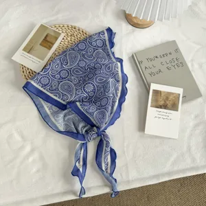 Blue paisley pattern triangle scarf, lightweight fabric, elegant styling accessory detail.