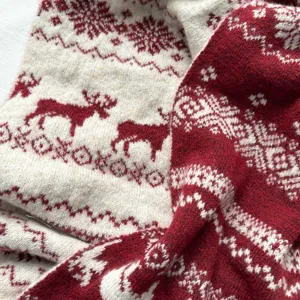 Cozy red and white winter knit scarf with classic Nordic reindeer and snowflake festive patterns.