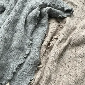 Gros plan de la texture du foulard triangle à volants tricoté, tissu chaud d'automne hiver doux.