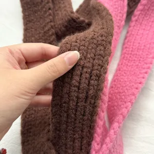 Close-up detail shot of the soft knitted winter scarf texture, premium material.