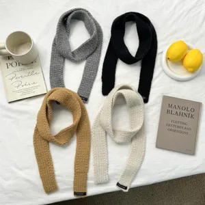 Minimalist solid color knitted narrow scarf for women, warm winter fashion accessory.