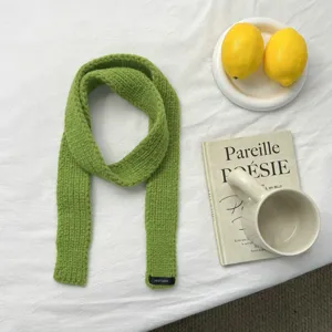 Green knitted slim scarf, perfect autumn winter fashion accessory for women daily wear.