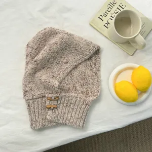 Closeup detail view of the stylish speckled knit balaclava hooded scarf with toggle buttons.