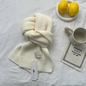 Détail d'écharpe en tricot d'hiver crème douillet, texture douce et épaisse, col chaud femme.