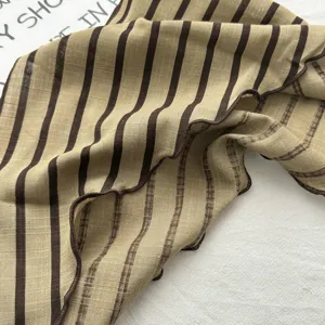 Detail shot of vintage brown striped cotton triangular scarf with lettuce edge texture.