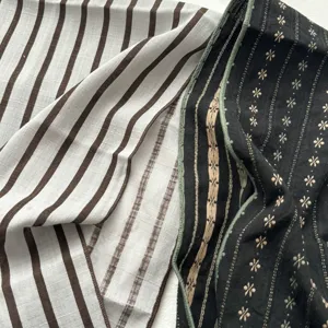Close up of vintage cotton scarf fabric details, showing striped and floral patterns clearly.