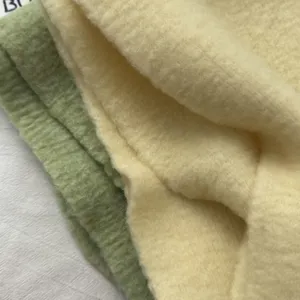Soft knitted scarf detail close-up, cozy winter neckerchief fabric in solid pastel colors.