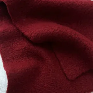 Detailed shot of a soft deep red knitted winter scarf, warm and cozy everyday style.