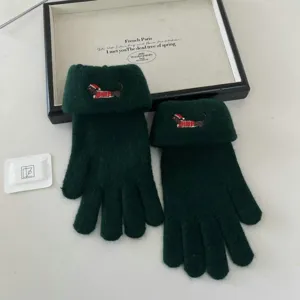Detail view of cute dog embroidered touchscreen knit gloves in dark green, cozy winter warmth.