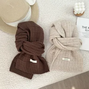 Detailed view of cozy 100% wool knit scarf featuring soft checkered texture, warm and stylish.