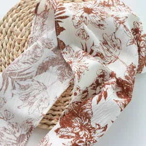 Close-up detail shot of the vintage brown floral print triangle scarf and waist skirt fabric.