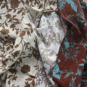 Detailed view of retro floral fabric with crinkled texture, perfect for stylish vintage apparel.